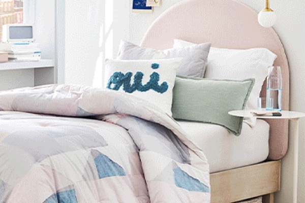 trendy pastel bedding in a dorm room